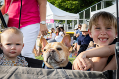 two children smiling with a french bulldog