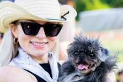 a woman smiling with a dog