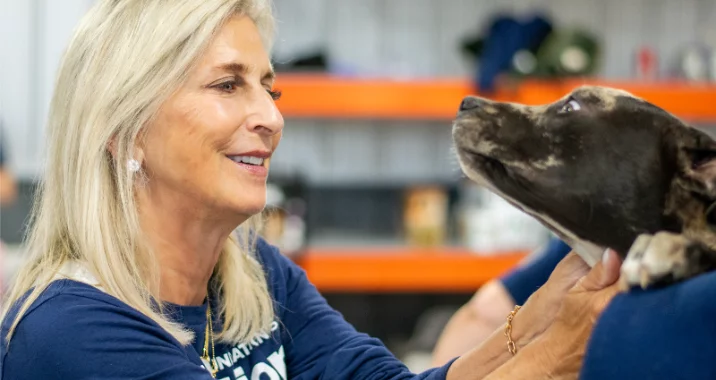 Cathy Bissell pets dog at BISSELL Pet Foundation's Operation Fix the Future Clinic in Grand Rapids