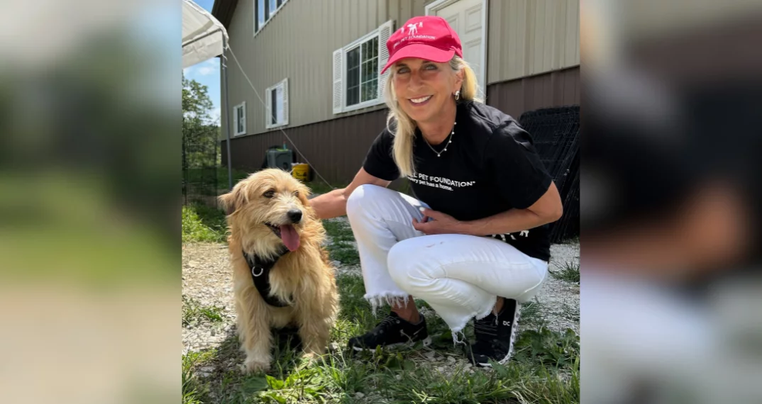 Cathy Bissell poses with dog saved from a puppy mill